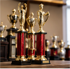 Illustrative group of gold-tone cup trophies on red columns